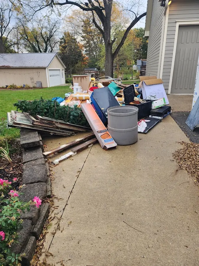 Dumpster being loaded with debris for Roofing Dumpster Rental in Windsor
